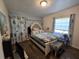 A relaxing bedroom featuring a queen-sized bed, wood flooring, and natural light from a window at 504 Se 35Th Ave, Ocala, FL 34471