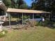 Covered carport providing protection for vehicles, surrounded by lush landscaping at 504 Se 35Th Ave, Ocala, FL 34471