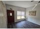 Inviting entryway boasts modern dark wood-look floors, a window, and a solid wood front door at 504 Se 35Th Ave, Ocala, FL 34471