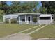 Charming single-story home featuring a well-maintained lawn, covered porch, and a welcoming facade at 504 Se 35Th Ave, Ocala, FL 34471