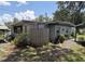 Cozy home exterior with stone pathway, mature trees, and ample greenery, providing curb appeal at 504 Se 35Th Ave, Ocala, FL 34471