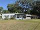 Charming single-story home featuring a quaint front porch and a well-manicured lawn under a sunny sky at 504 Se 35Th Ave, Ocala, FL 34471