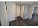 Clean hallway featuring wood floors, neutral walls, and access to multiple rooms and storage closets at 504 Se 35Th Ave, Ocala, FL 34471