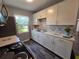 Bright kitchen with white cabinets, stainless steel appliances, and modern backsplash at 504 Se 35Th Ave, Ocala, FL 34471
