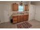 Galley kitchen featuring wood cabinets, tile countertops, and stainless steel sink at 504 Se 35Th Ave, Ocala, FL 34471