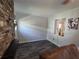 Living area showcasing dark wood-look floors, brick fireplace, and an open doorway at 504 Se 35Th Ave, Ocala, FL 34471