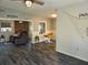 Open-concept living area featuring modern dark wood-look floors, brick fireplace, and comfortable seating at 504 Se 35Th Ave, Ocala, FL 34471