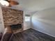 Inviting living space with dark wood-look floors, brick fireplace, and a bright window at 504 Se 35Th Ave, Ocala, FL 34471