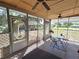 Relaxing screened-in patio featuring a ceiling fan, lighting, table, and chairs for outdoor enjoyment at 504 Se 35Th Ave, Ocala, FL 34471