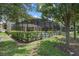View of a screened-in pool, the lush backyard landscaping enhances privacy and a relaxing atmosphere at 5241 Oakbourne Ave, Davenport, FL 33837