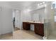 Bathroom featuring double vanity, tiled floors, and a spacious walk-in shower at 5241 Oakbourne Ave, Davenport, FL 33837