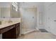 Bathroom featuring tiled walk-in shower and vanity with modern fixtures at 5241 Oakbourne Ave, Davenport, FL 33837