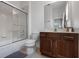 Neutral bathroom featuring a wood vanity, shower/tub combo, and essential fixtures creating a clean and functional space at 5241 Oakbourne Ave, Davenport, FL 33837