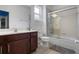Well-lit bathroom featuring a dark-wood vanity with marble countertops, a toilet, and a tiled tub/shower combination at 5241 Oakbourne Ave, Davenport, FL 33837