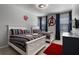 Bright bedroom featuring two beds with striped linens and superhero decor, creating a fun, themed atmosphere at 5241 Oakbourne Ave, Davenport, FL 33837