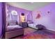 Charming bedroom features twin beds, soft purple accents, and whimsical Rapunzel decorations for a playful atmosphere at 5241 Oakbourne Ave, Davenport, FL 33837