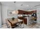 Open-concept kitchen and dining area with granite countertops and stainless steel appliances at 5241 Oakbourne Ave, Davenport, FL 33837