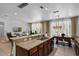 Open kitchen and living area with a breakfast bar, modern lighting, and tile flooring at 5241 Oakbourne Ave, Davenport, FL 33837