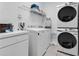 Functional laundry room with modern washer, dryer, and storage shelving at 5241 Oakbourne Ave, Davenport, FL 33837