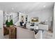Bright living room with tile floors, modern furniture, and a staircase leading to the upper level at 5241 Oakbourne Ave, Davenport, FL 33837