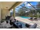 Relaxing screened-in pool area with comfortable lounge seating and dining, perfect for outdoor enjoyment at 5241 Oakbourne Ave, Davenport, FL 33837