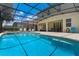 Inviting screened-in pool featuring a tanning ledge, lounge chairs, and outdoor seating for ultimate relaxation at 5241 Oakbourne Ave, Davenport, FL 33837