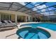 Enjoy this screened pool and spa, perfect for entertaining or relaxing outdoors on the tanning deck at 5241 Oakbourne Ave, Davenport, FL 33837