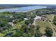 Expansive aerial view of home site surrounded by lush greenery, near a lake, showcasing a serene natural setting at 5380 County Road 122, Wildwood, FL 34785