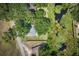 An aerial view of the home nestled on the property near a body of water at 5380 County Road 122, Wildwood, FL 34785