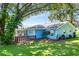 View of the backyard with mature trees and a screened-in lanai at 5380 County Road 122, Wildwood, FL 34785