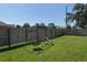 Backyard features a swing set and slide, offering fun outdoor activities for children at 5380 County Road 122, Wildwood, FL 34785