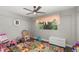 bedroom with ceiling fan, colorful rug, neutral grey walls and dark floors at 5380 County Road 122, Wildwood, FL 34785