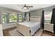 Comfortable bedroom with a window bench overlooking a lush backyard at 5380 County Road 122, Wildwood, FL 34785