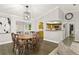 Open dining room featuring hardwood floors and a stylish light fixture, adjacent to the kitchen at 5380 County Road 122, Wildwood, FL 34785