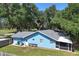 The exterior features a well-maintained lawn, charming bench, and blue accents that enhance its curb appeal at 5380 County Road 122, Wildwood, FL 34785