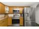 Kitchen featuring stainless steel appliances including a refrigerator, oven, and microwave at 5380 County Road 122, Wildwood, FL 34785