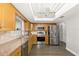 Kitchen with stainless steel appliances, stone countertops, and wood-look flooring at 5380 County Road 122, Wildwood, FL 34785
