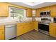Eat-in kitchen featuring a stainless steel oven, microwave, and wood-look flooring at 5380 County Road 122, Wildwood, FL 34785