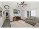 Comfortable living room with dark wood floors, a fireplace, and a large television at 5380 County Road 122, Wildwood, FL 34785