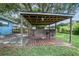 Backyard outdoor bar is made of rustic wood and corrugated metal, set on a stained deck at 5380 County Road 122, Wildwood, FL 34785