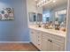 Bathroom vanity featuring double sinks, tile floors, and ample cabinet storage at 5437 Compass Pt # 00, Oxford, FL 34484