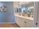 Bathroom vanity featuring double sinks, tile floors, and ample cabinet storage at 5437 Compass Pt # 00, Oxford, FL 34484