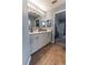 Bathroom vanity featuring double sinks, tile floors, and ample cabinet storage at 5437 Compass Pt # 00, Oxford, FL 34484