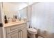 Bathroom with granite sink and shower featuring a shower curtain at 5437 Compass Pt # 00, Oxford, FL 34484