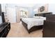 Bright bedroom featuring a slider to the lanai, a large bed, and neutral carpet at 5437 Compass Pt # 00, Oxford, FL 34484