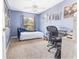 This cozy bedroom features a blue chaise lounge, neutral carpet, and a ceiling fan for comfort at 5437 Compass Pt # 00, Oxford, FL 34484