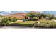 Front exterior view of the clubhouse surrounded by lush greenery and landscaping at 5437 Compass Pt # 00, Oxford, FL 34484