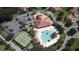 Aerial view of community featuring a pool, tennis courts, clubhouse, and parking at 5437 Compass Pt # 00, Oxford, FL 34484