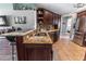 Modern kitchen with granite countertops, dark wood cabinets, and stainless steel appliances at 5437 Compass Pt # 00, Oxford, FL 34484