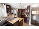 Stylish kitchen featuring granite countertops, stainless steel appliances, and dark wood cabinetry at 5437 Compass Pt # 00, Oxford, FL 34484